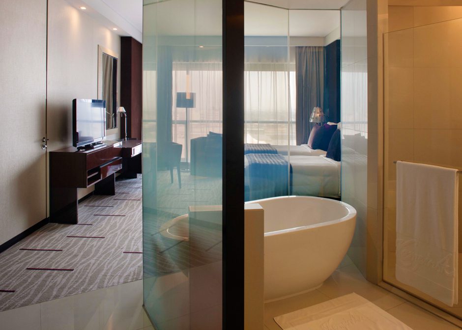 Contemporary suite with bathtub and TV