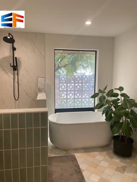Modern bathroom with bathtub and plants