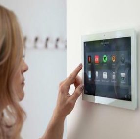 Woman interacting with home control panel