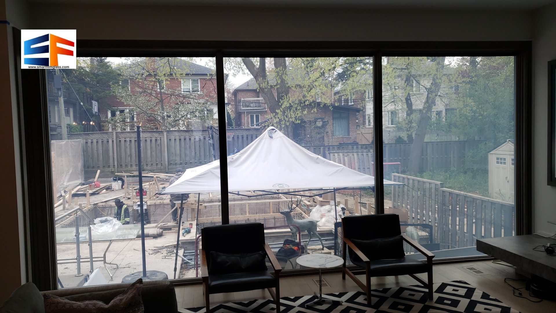 Backyard renovation with white tent visible