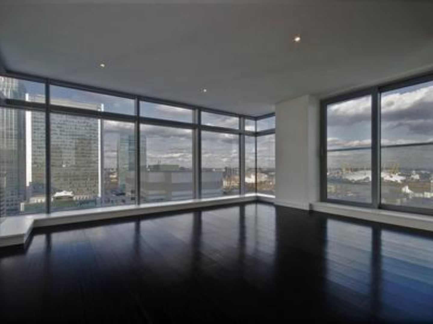 Empty modern apartment with city skyline view