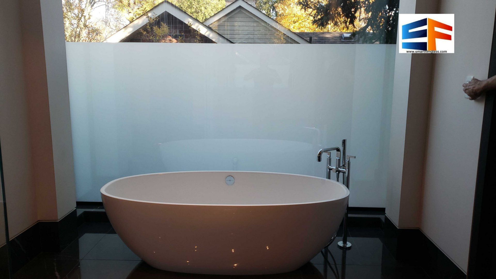 White freestanding bathtub by frosted window