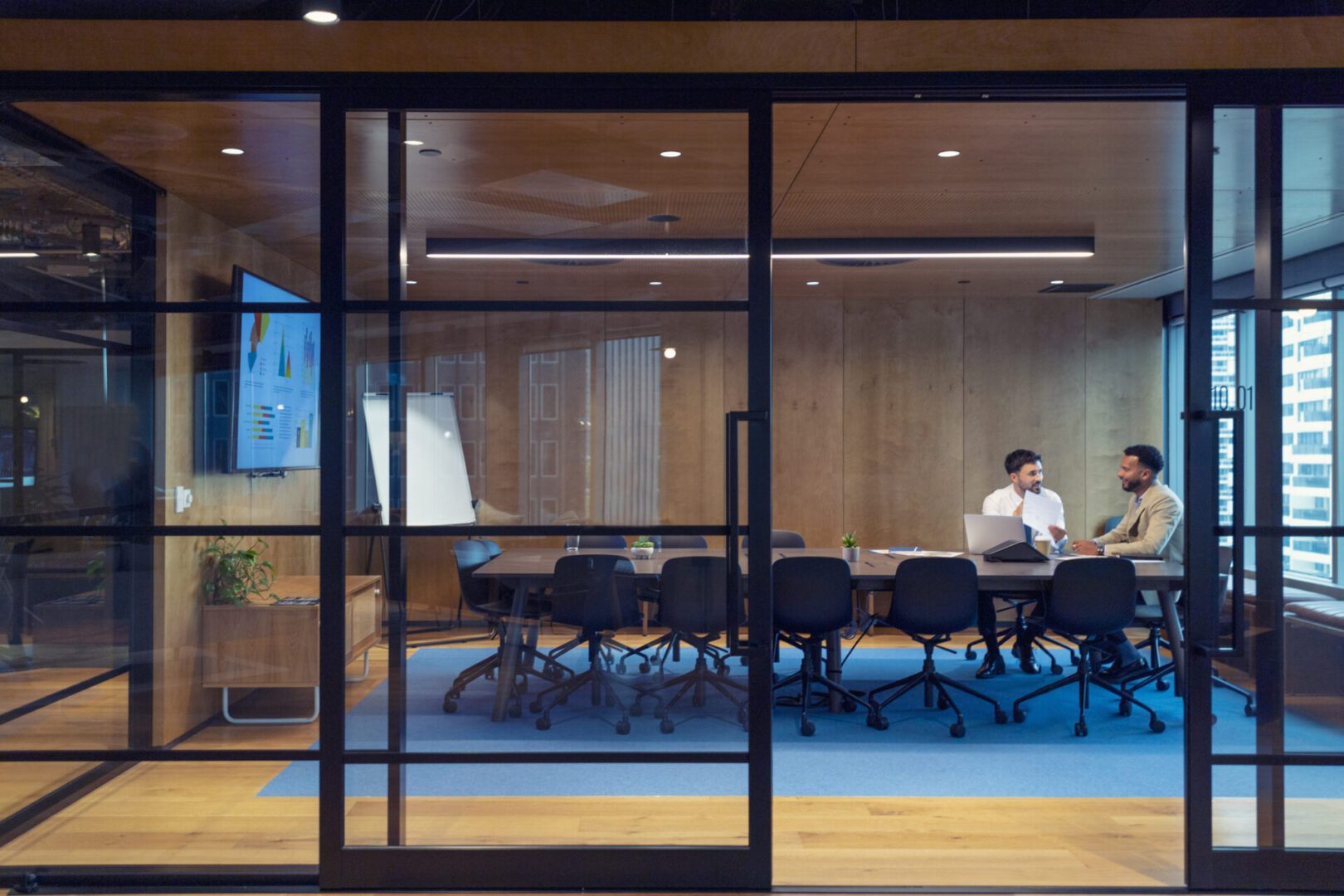 Business people working in a board room with a laptop and digital tablet. Manager working with an employee, job interview, sales, lawyer or a financial advisor.