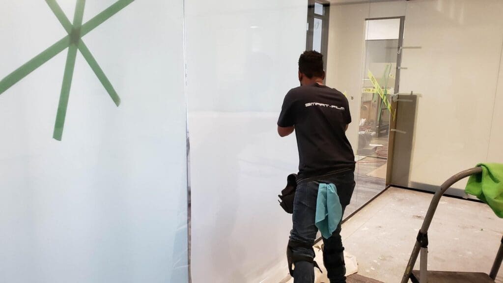 Professional Smart Film installation on commercial office glass.