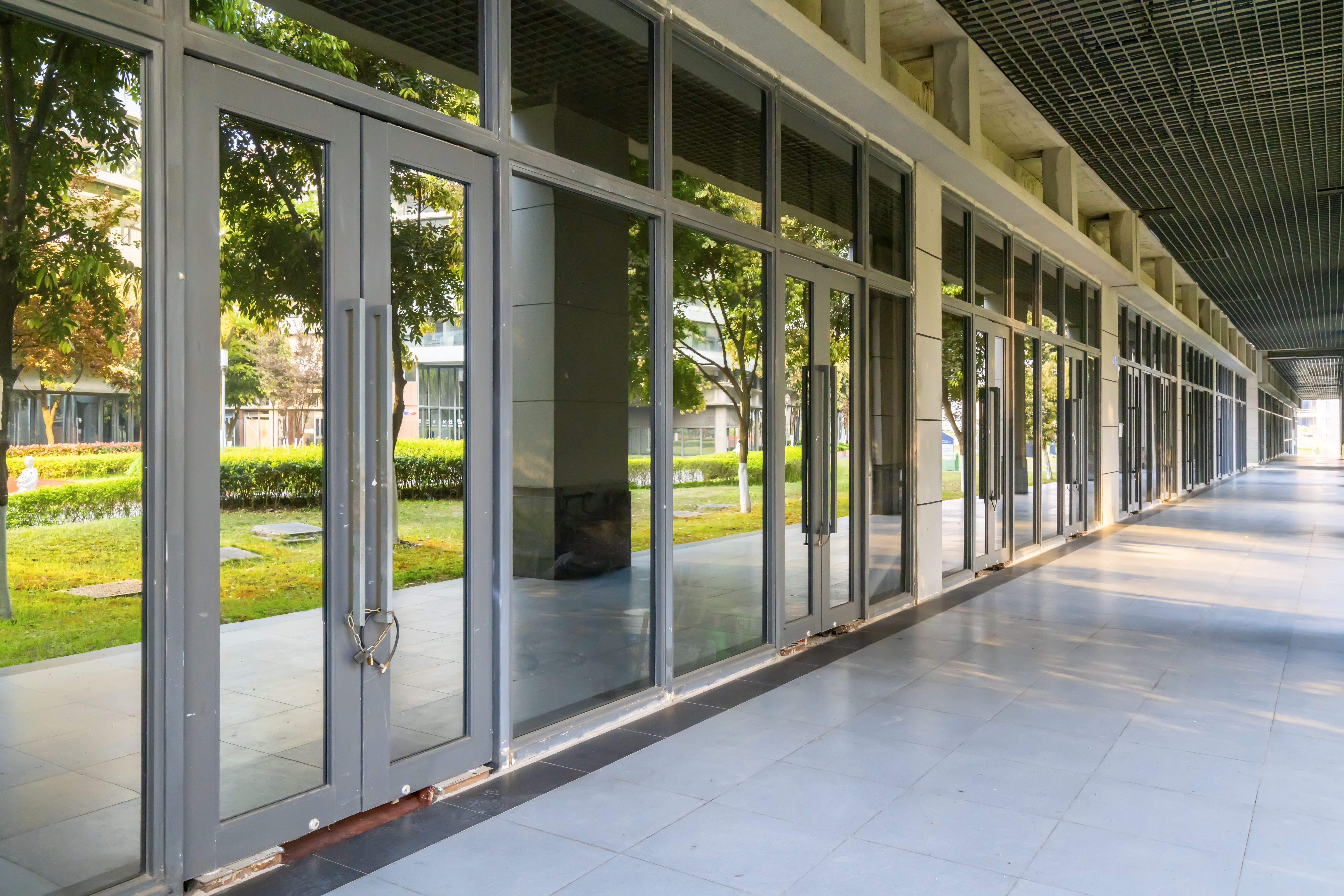 Glass windows reflecting green landscape