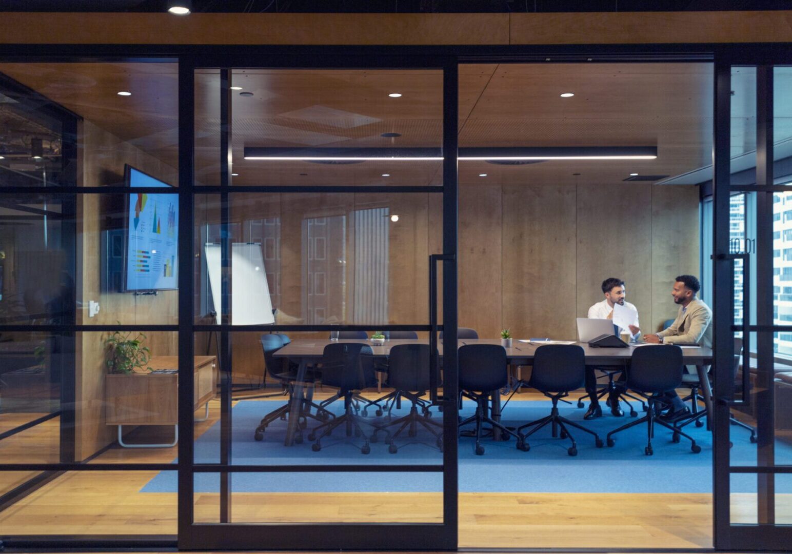 Business people working in a board room with a laptop and digital tablet. Manager working with an employee, job interview, sales, lawyer or a financial advisor.